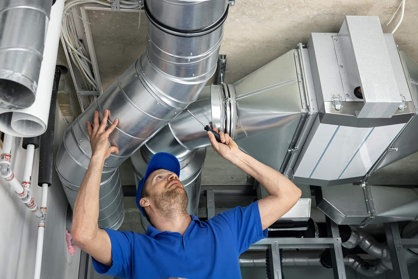 HVAC technician inspecting and repairing air ducts in Ladera Ranch