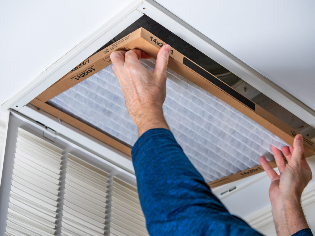 HVAC technician replacing a home air filter in Ladera Ranch