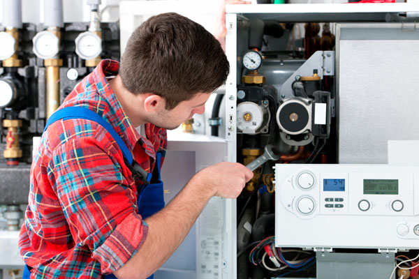 Heating technician repairing boiler controls in Ladera Ranch