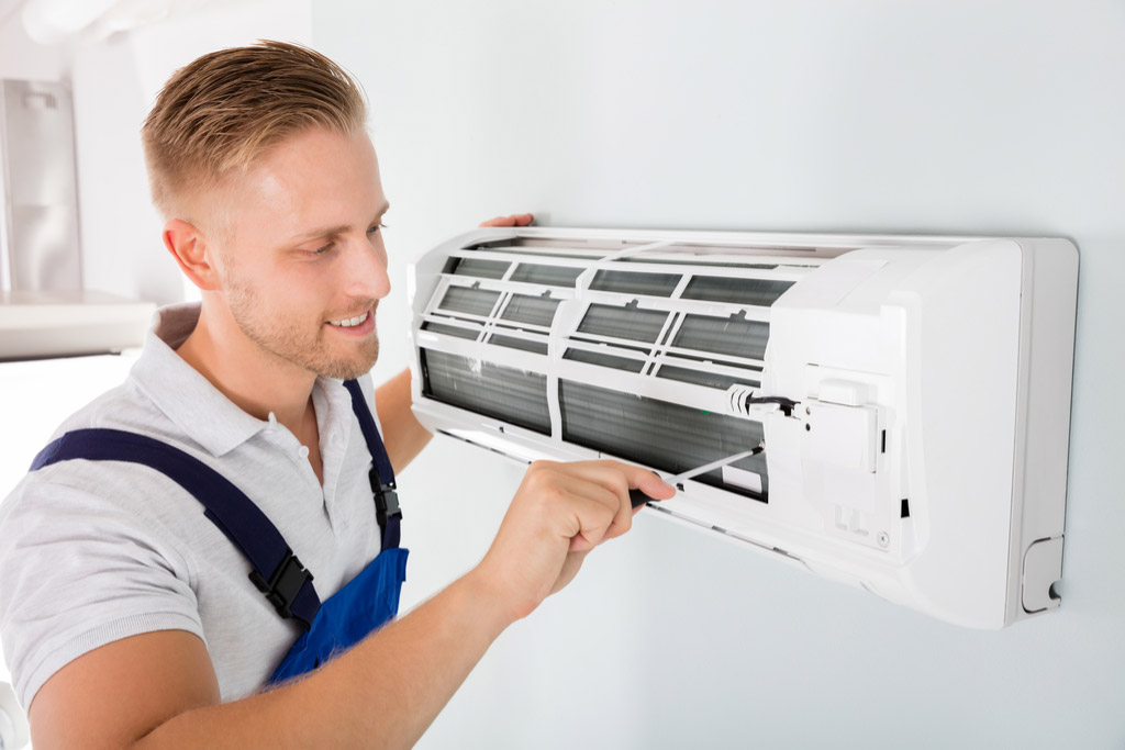 HVAC technician maintaining a ductless air conditioner in Ladera Ranch