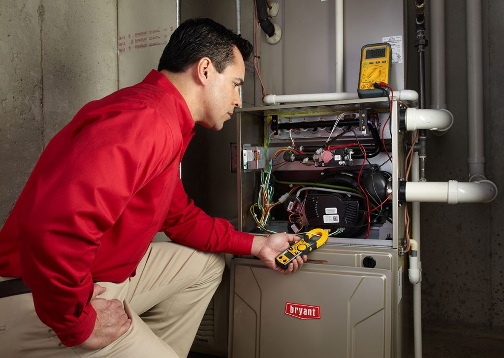 Heating technician diagnosing a furnace repair in Ladera Ranch