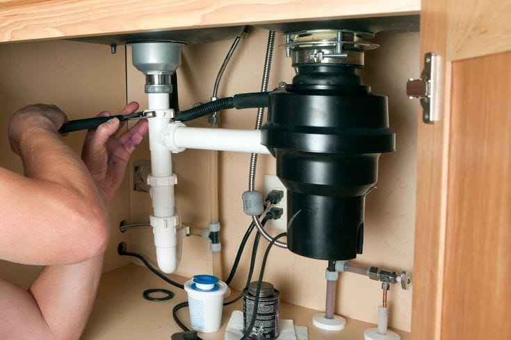 Plumber repairing a garbage disposal in Ladera Ranch
