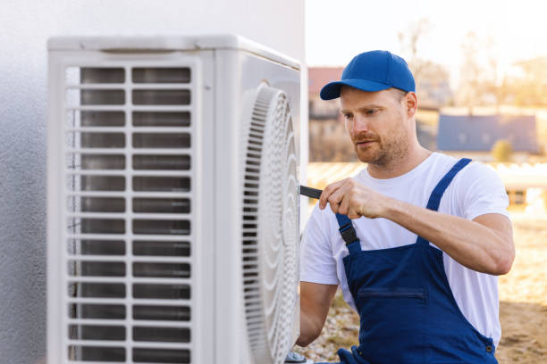 HVAC technician servicing an outdoor air conditioner in Ladera Ranch